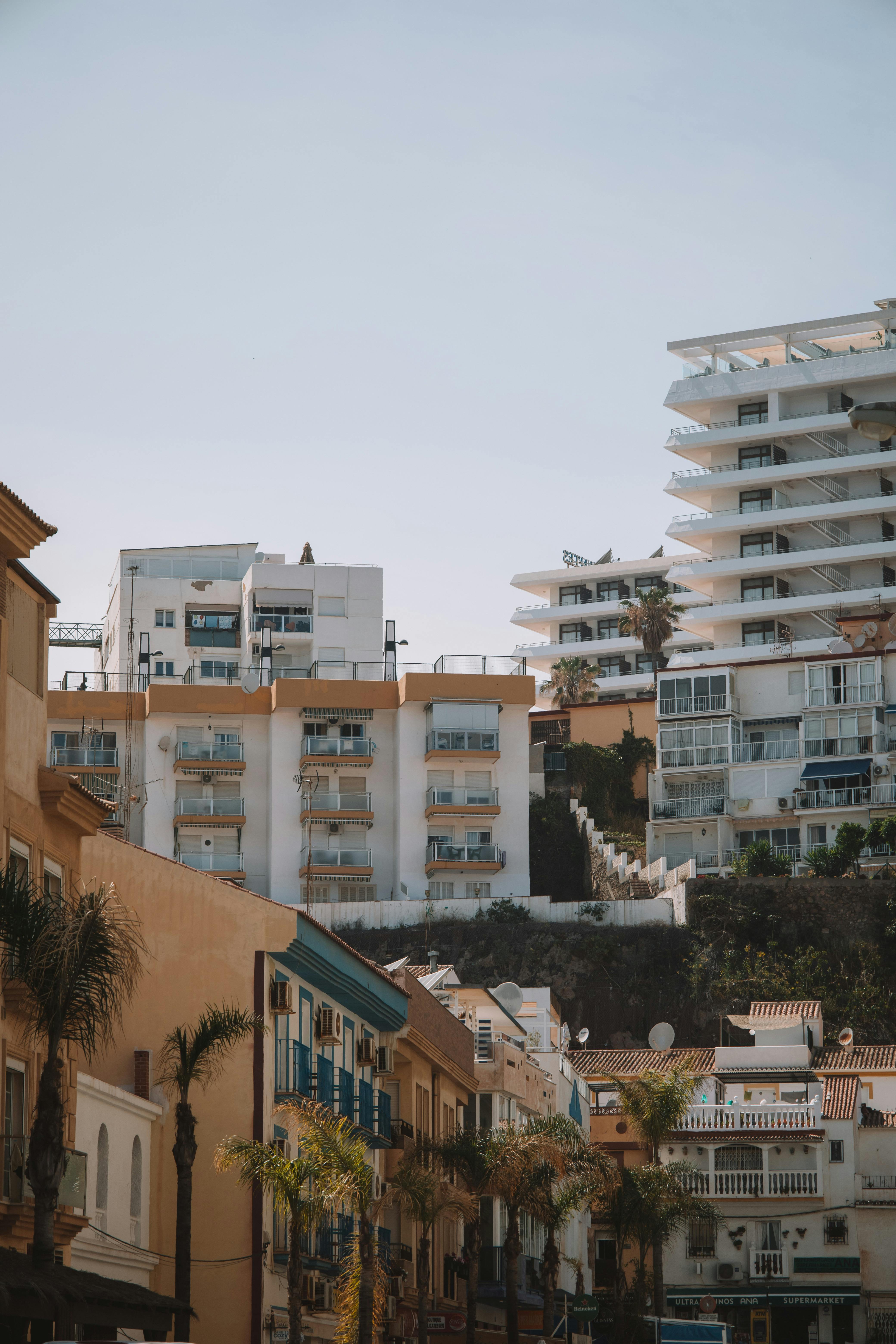 Free Scenic view of contemporary apartment buildings under a clear sky in Málaga, Spain showcasing urban architecture. Stock Photo